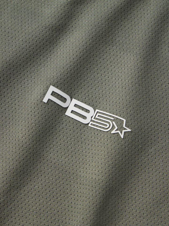 Close-up of the PB5star logo on the breathable mesh fabric of a Vented Sleeveless Tee in pavement.