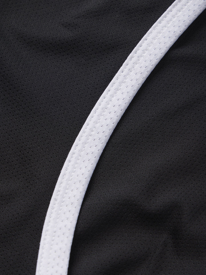  Detailed texture of PB5star's women's Core Tank in black with a contrasting white trim, showcasing the high-quality, breathable mesh fabric designed for pickleball players seeking comfort and style.