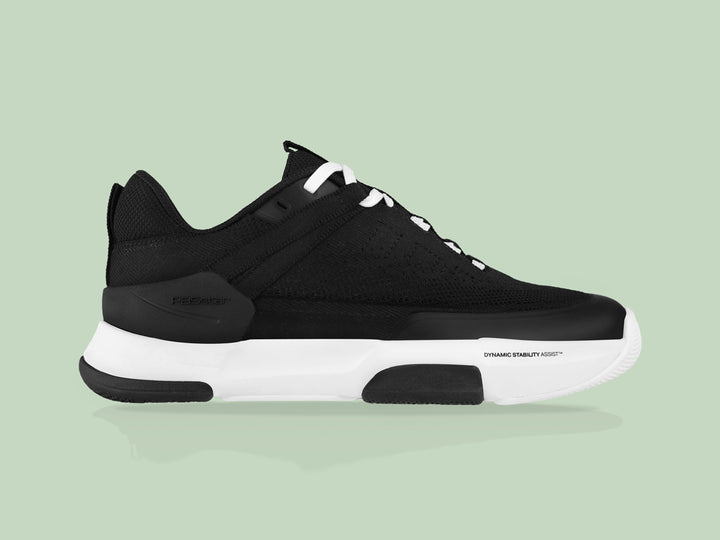 Side view of black and white PB5star Court2 performance sneaker featuring breathable mesh upper, durable sole with hexagonal grip pattern, and modern design.