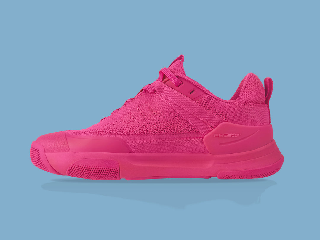 Side view of pink PB5star Court2 performance sneaker featuring breathable mesh upper, durable sole with hexagonal grip pattern, and modern design.