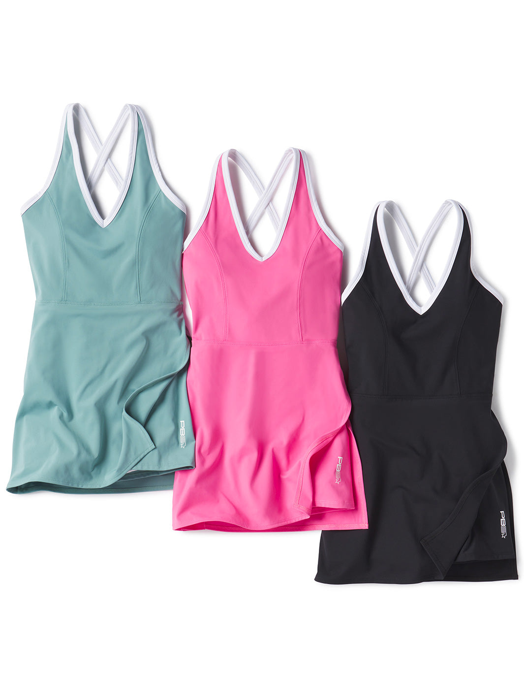 Three PB5star side split court dresses in arctic, pink, and black, laid flat to showcase their sleek design with white trim and crisscross straps. Stylish and functional activewear for pickleball players.