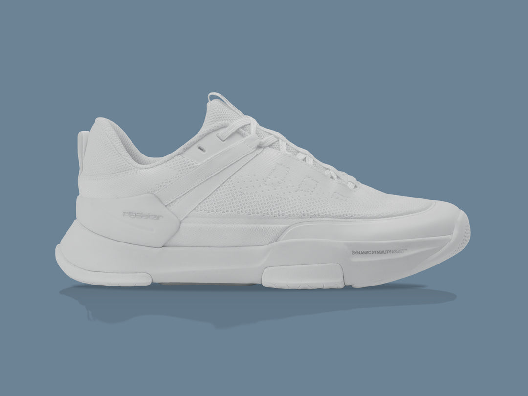 PB5 Court2 pickleball shoe in white, showcasing its sleek design, breathable knit upper, and dynamic stability assist technology, positioned against a soft blue background.