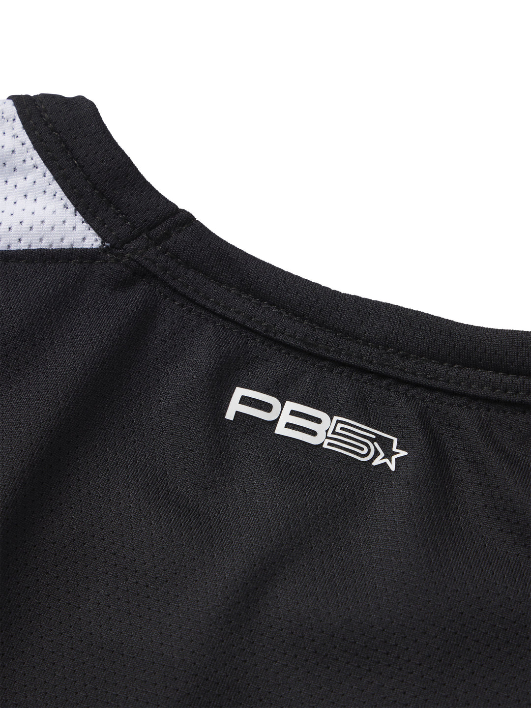 Detail of PB5Star logo on the black Core Vented Tee with contrast white mesh for breathability and athletic style.