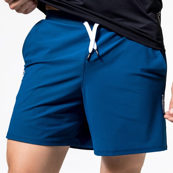 Close up of a man wearing Pb5star Signature Court Short in astral blue, designed for active wear and comfort.