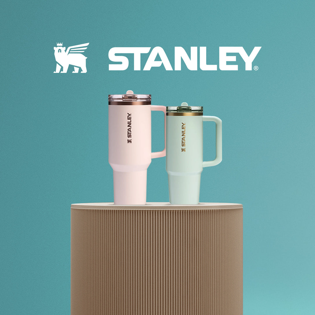 
Stanley tumblers in pastel pink and green displayed on a beige stand against a teal background, highlighting durable and stylish drinkware for on-the-go hydration, featured in The Ultimate Gear Giveaway with PB5star.