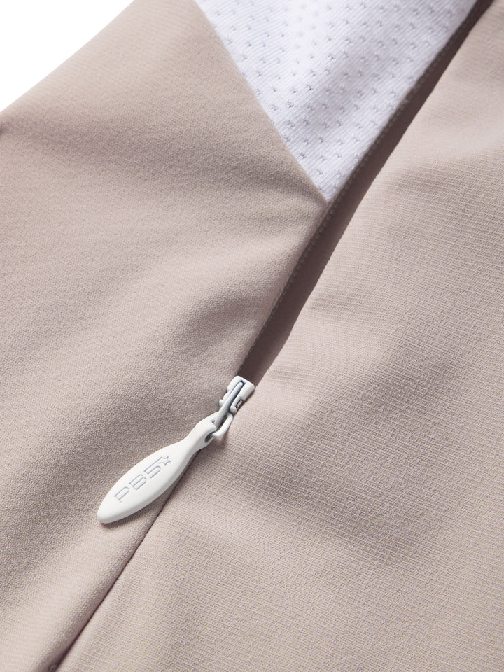 Close-up of a PB5star Vented Court Short in soft clay with a subtle zippered pocket and white mesh lining for athletic utility.