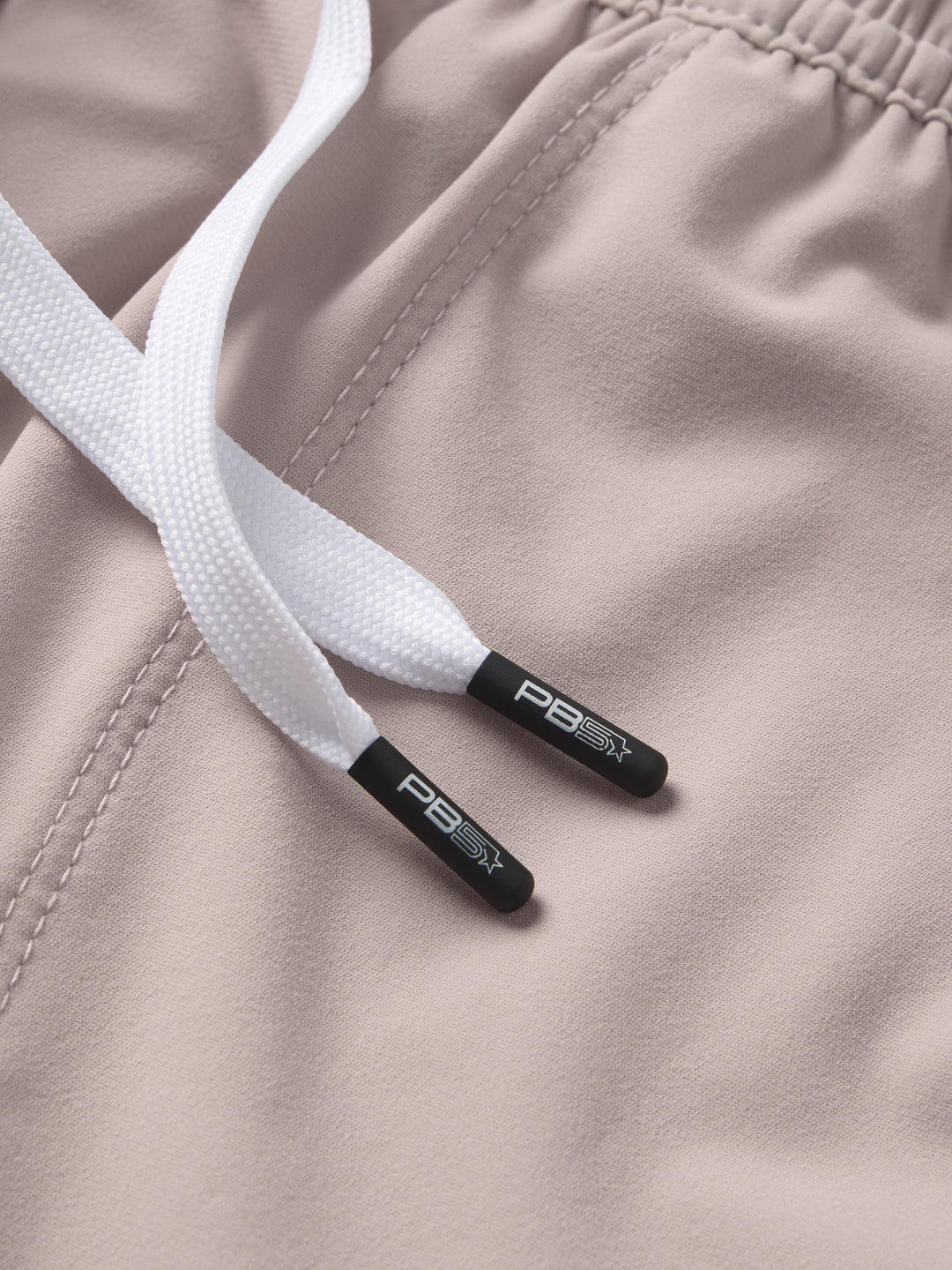 Close-up of PB5star's Vented Court Short in soft clay drawstrings with branded tips, highlighting the shorts' adjustable fit.