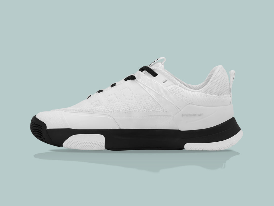 Side view of the PB5 Court2 white and black athletic shoe with PB5star branding, breathable upper, and cushioned black outsole.