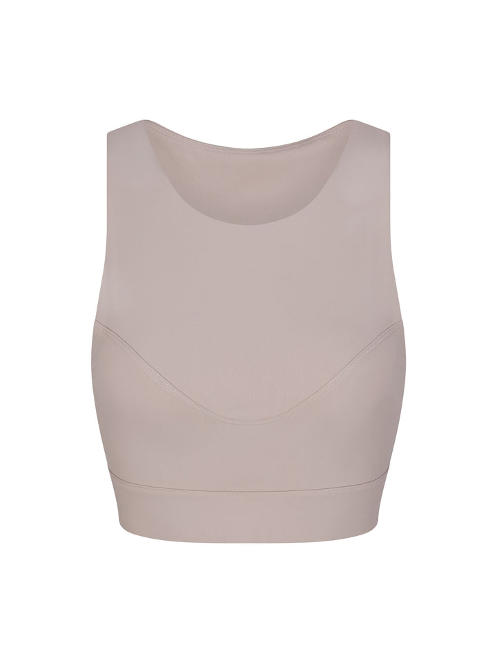 Racer Back Sports Bra with a high neck line, front view in soft clay.