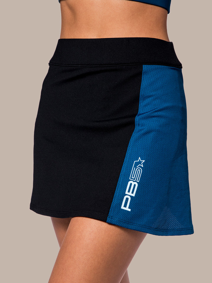 Close-up of the PB5Star Mesh Panel Pickleball Skirt in black with astral blue accent, designed for style and performance on the court.