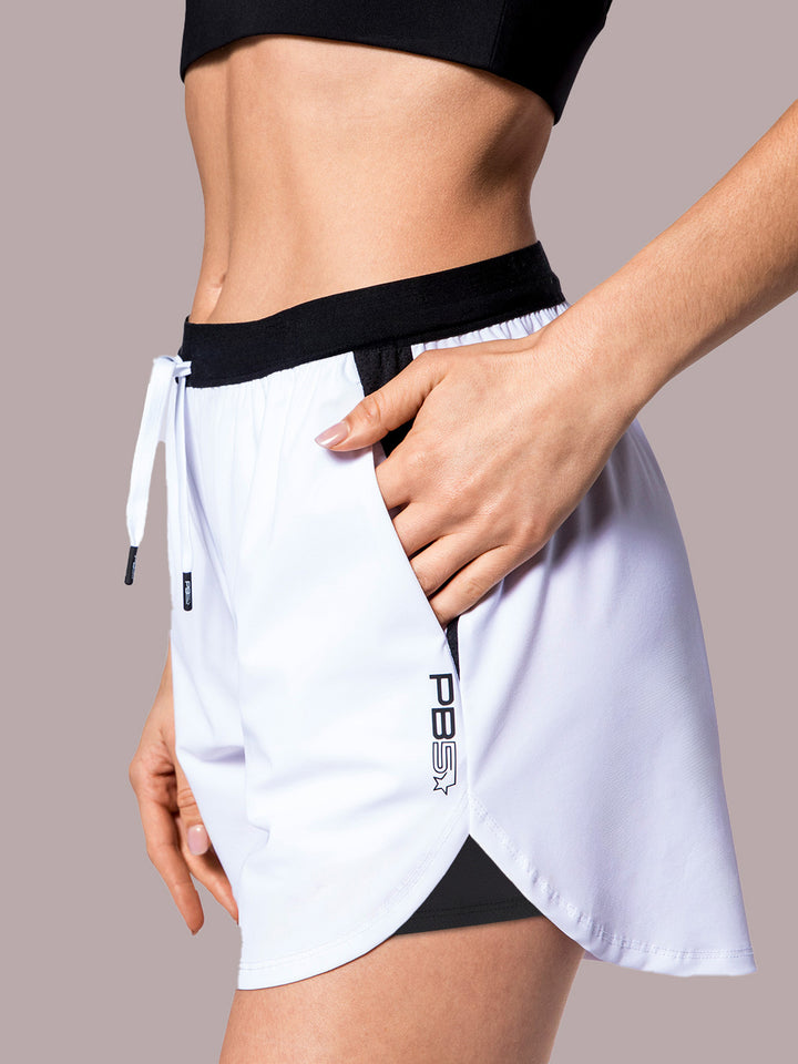 Detail of PB5star white Signature Court Shorts with a sleek black waistband and convenient side pocket, designed for athletic performance.