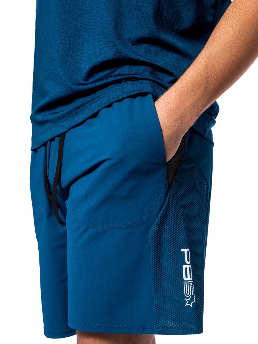 Side view of a man wearing PB5star astral blue Vented Court Shorts, highlighting the mesh fabric for enhanced airflow.