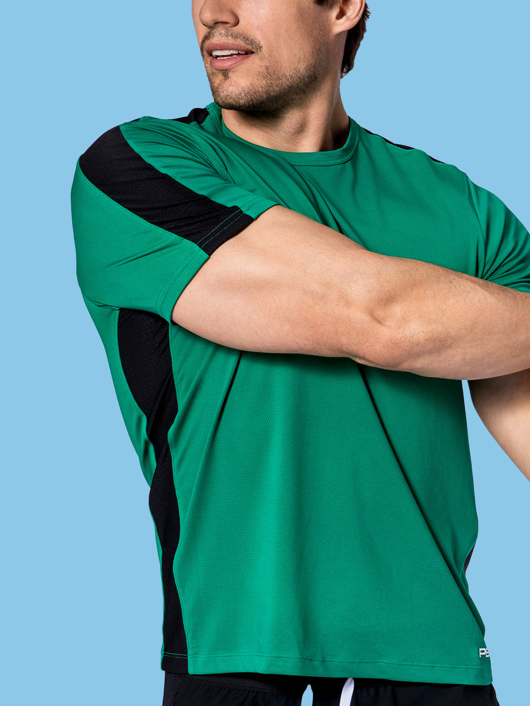 Confident male model in PB5Star's Core Vented Tee in jade with black vented panels, designed for optimal performance and style.